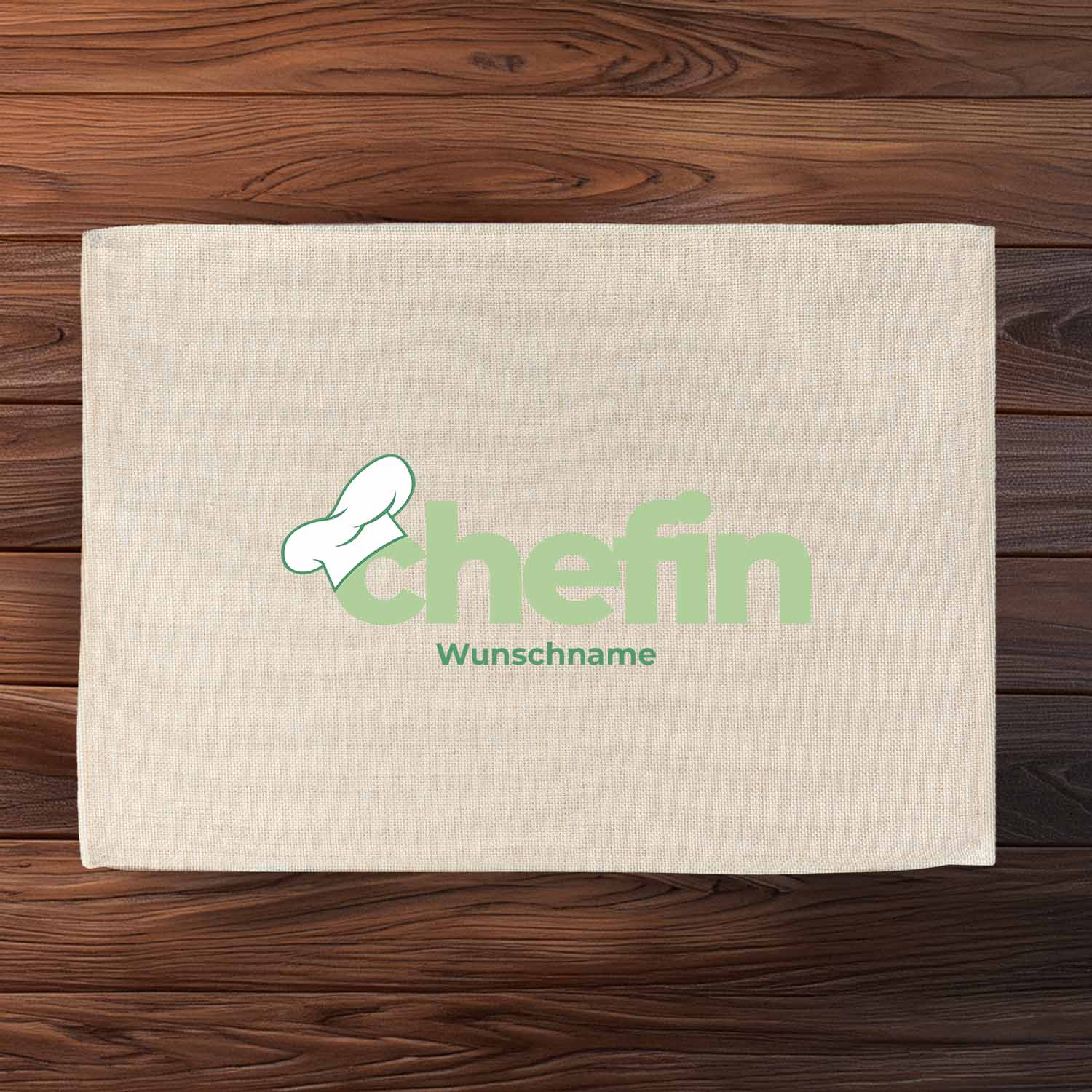 Tischset Chefin mit Wunschname, hellbeige, bedruckt mit Kochmütze und mintgrünem Schriftzug auf Holzgrund