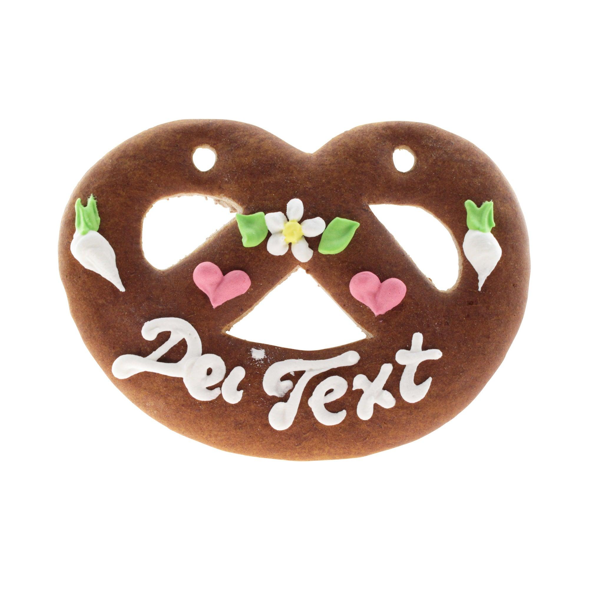 Lebkuchen-Herz Brezel mit weißem Schriftzug "Dei Text", rosa Herzen, Blumen und Radieschen Zuckergussverzierung