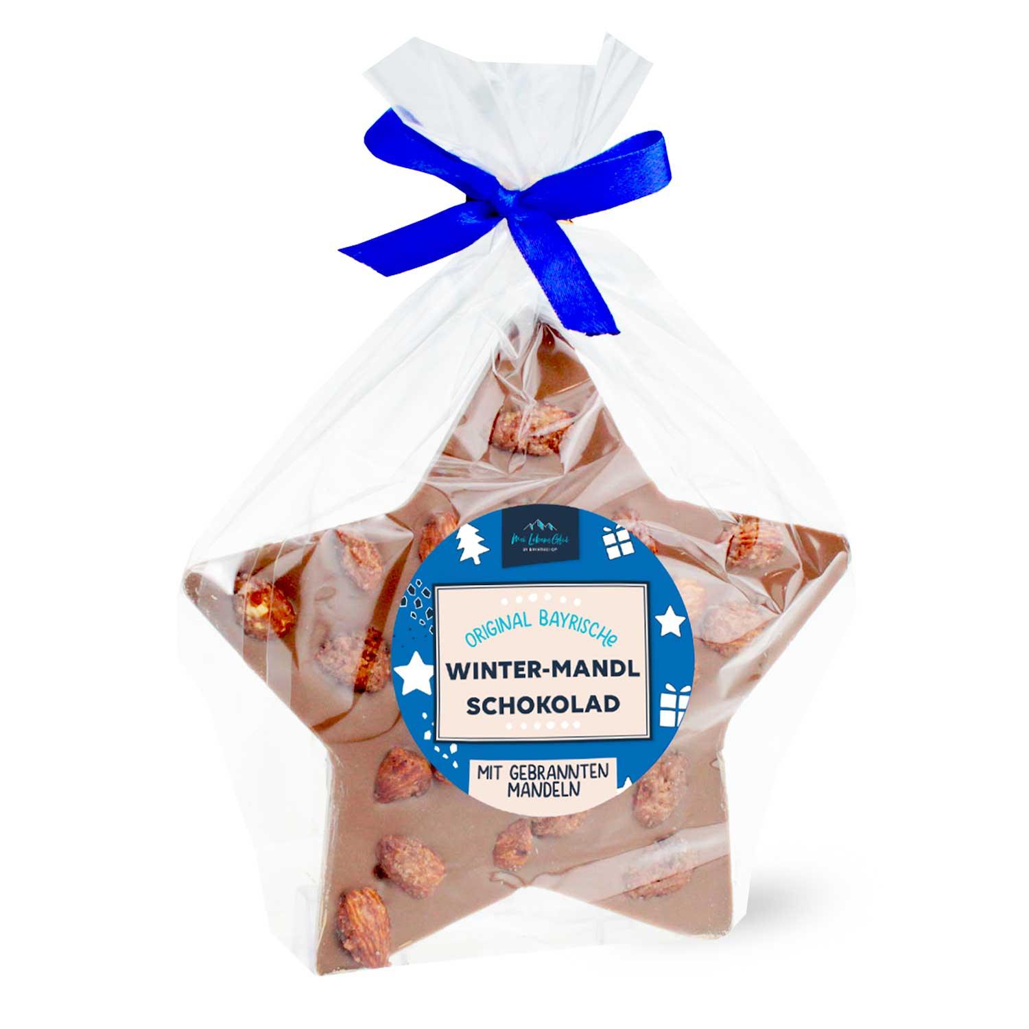Milchschokolade-Stern mit gebrannten Mandeln, verpackt mit blauer Schleife – Original Bayrische Winternascherde.