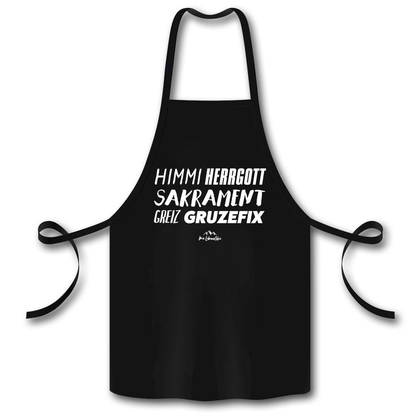 Schwarze Schürze Himmiherrgottsakrament mit weißem Spruch und Bindebändern für Küche oder Grill.