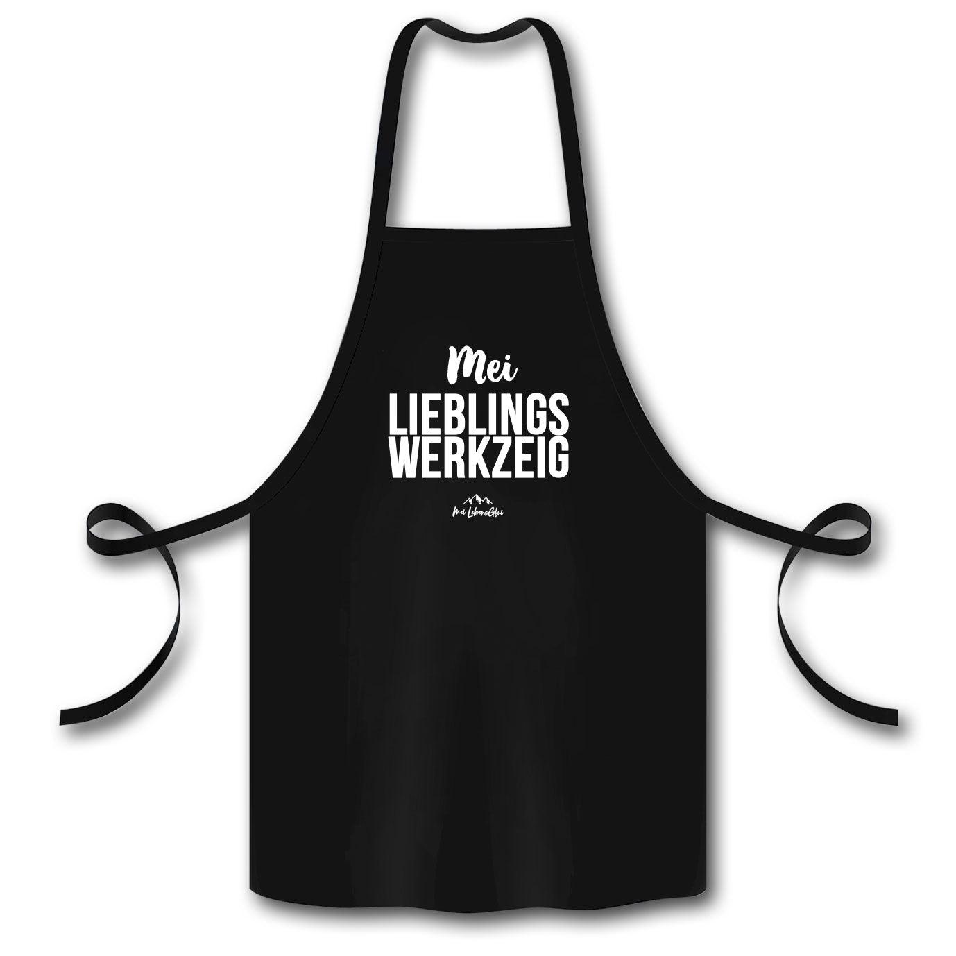 Schürze Mei Lieblingswerkzeig in Schwarz mit weißem Schriftzug, ideal für Köche und Grillmeister.