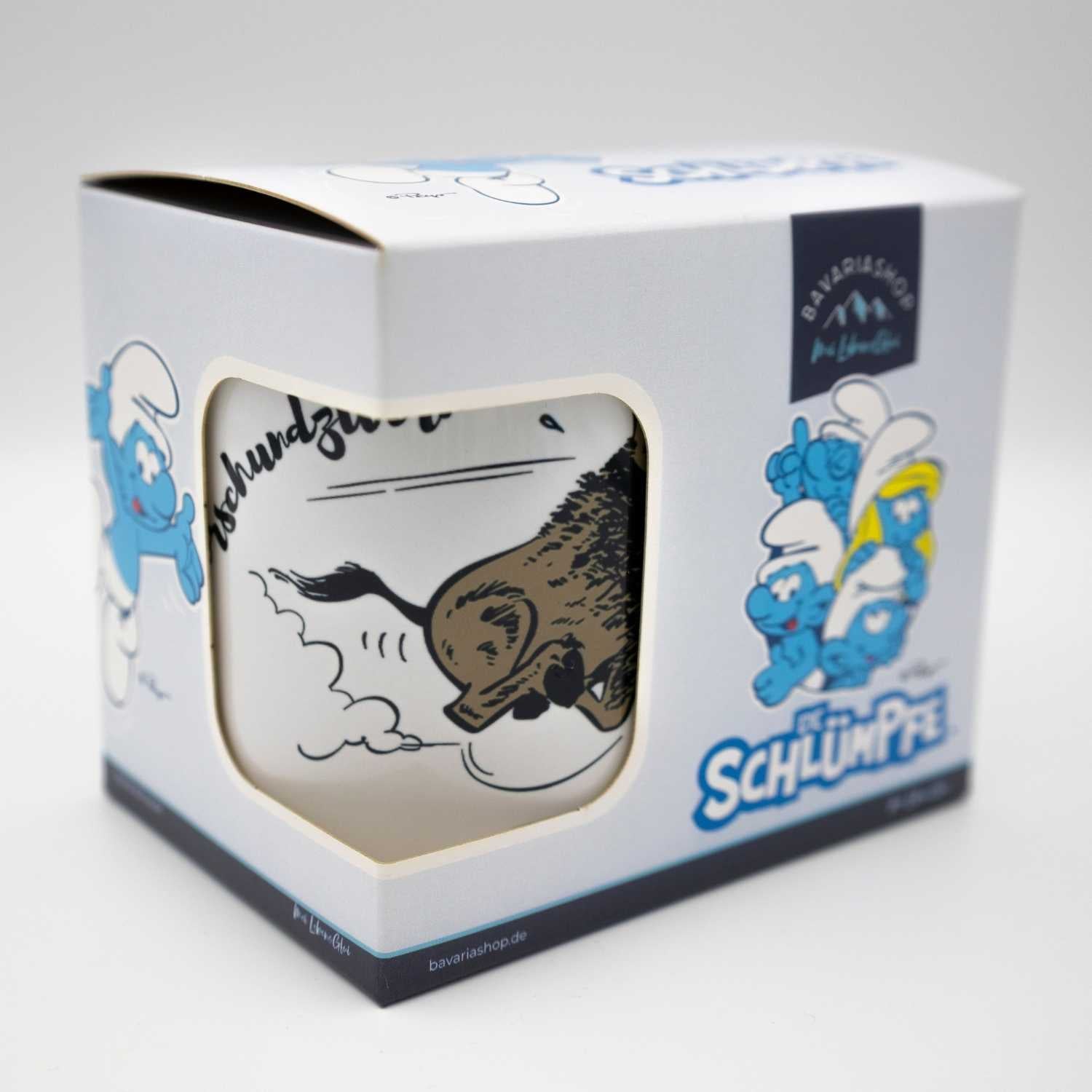 Die Schlümpfe Tasse "Himmeorschundzwirn" in offener Geschenkbox, mit Comic-Wildschwein-Motiv und Schlumpf-Druck.