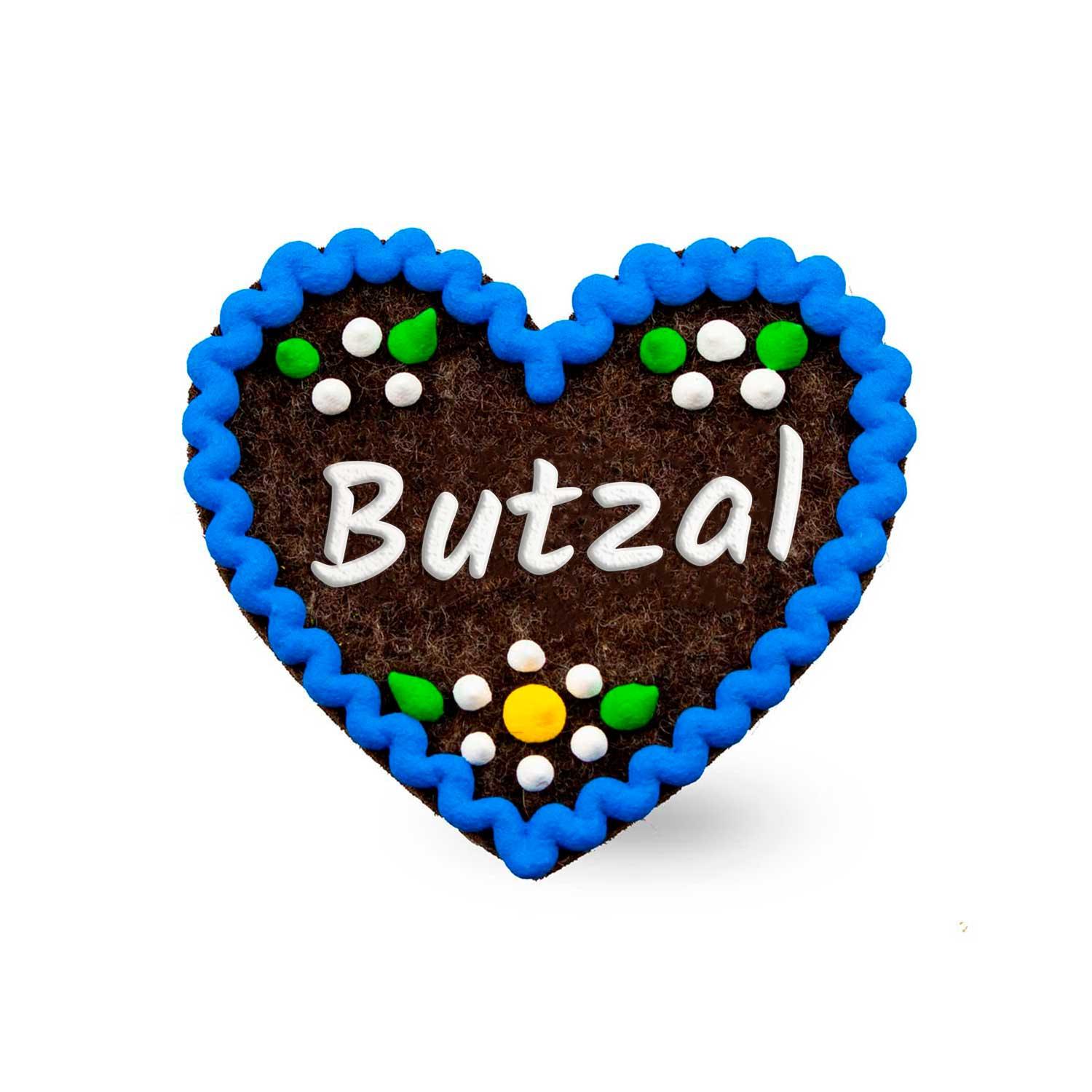 Brauner Filzherz-Anstecker Butzal mit blauem Zuckergussrand und bunter Zuckerrosen-Dekoration.