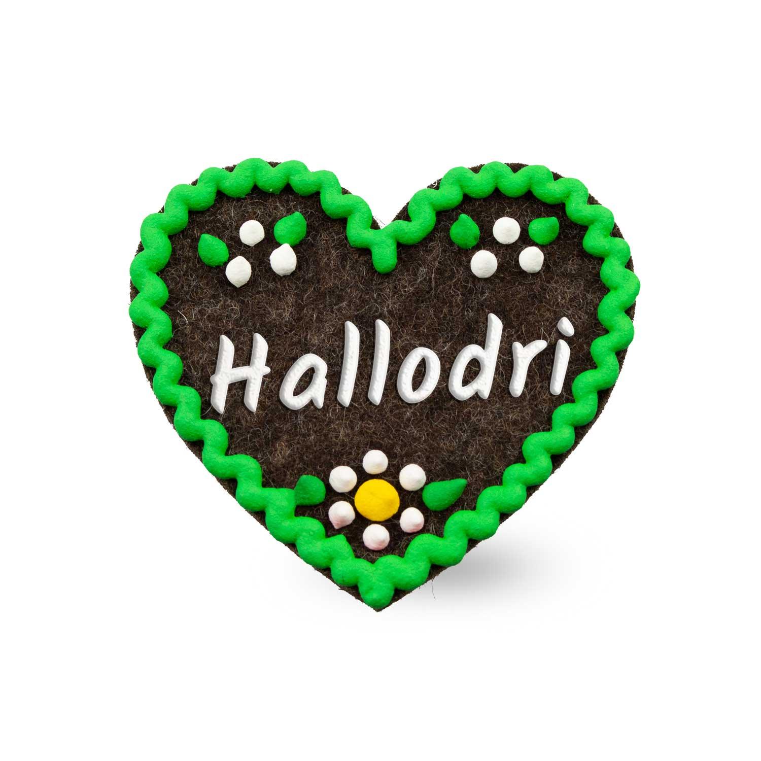 Brauner Filzherz-Anstecker "Hallodri" mit grüner Wellenbordüre und bunten Blumenapplikationen.