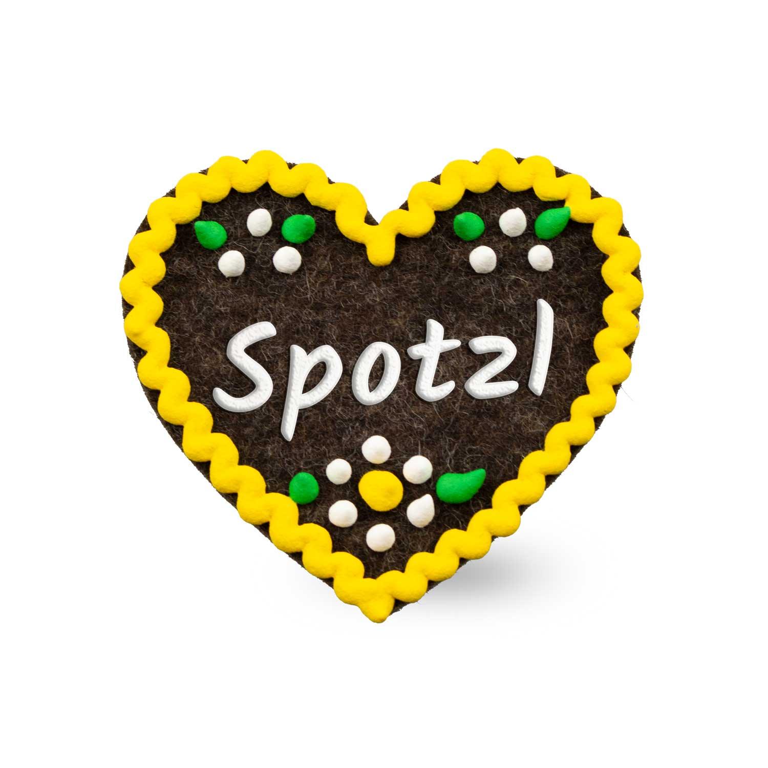 Brauner Filzherz-Anstecker Spotzl mit weißer Schrift, gelbem Rand und bunten Filzblumen darauf