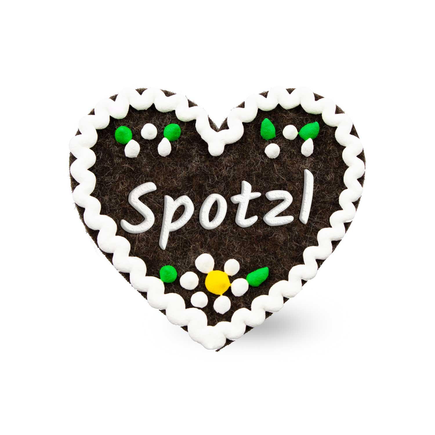 Dunkelbrauner Filzherz-Anstecker Spotzl mit weißer Schrift, weißer Zackenborte und bunten Blütenapplikationen.