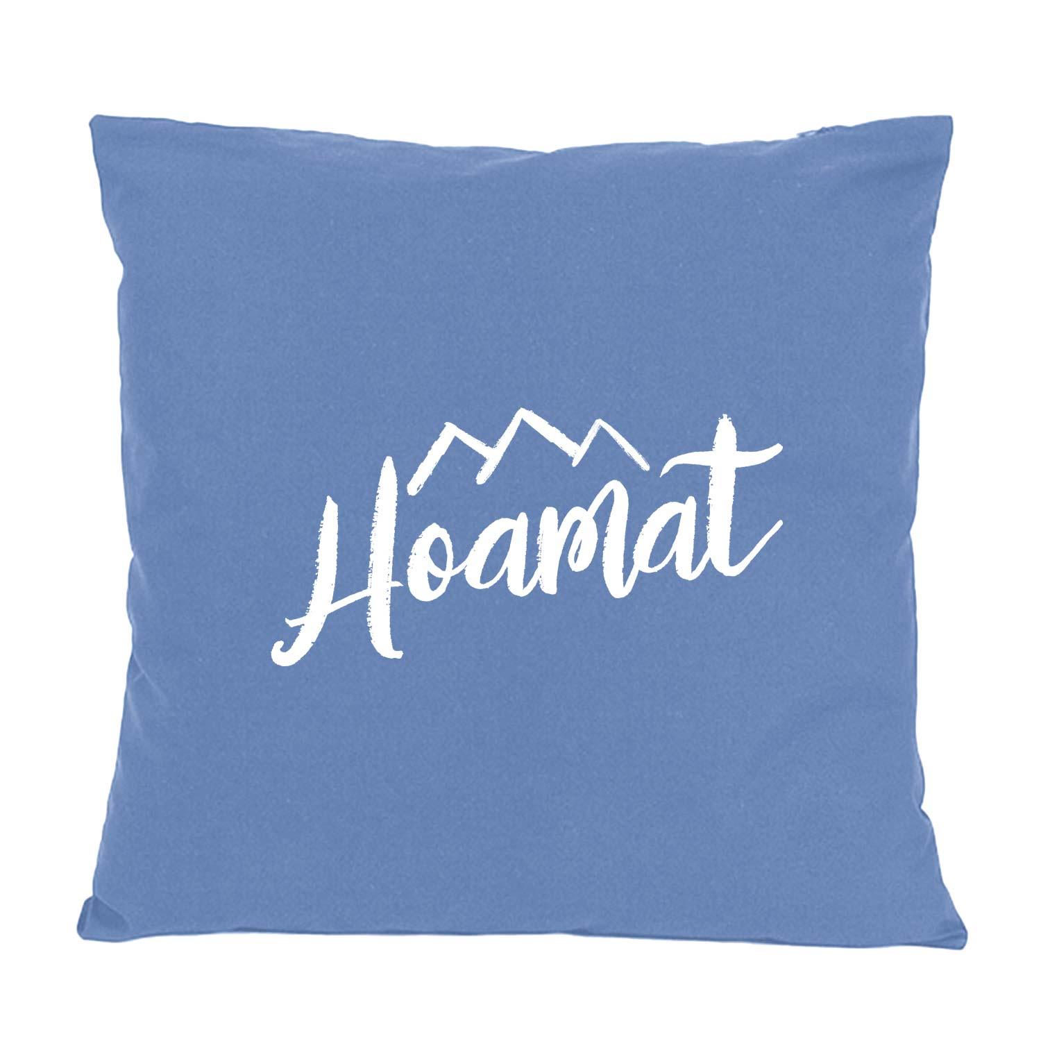 Blaues Dekokissen Hoamat mit weißem Schriftzug und Bergmotiv, ideal für gemütliche Wohnzimmer.