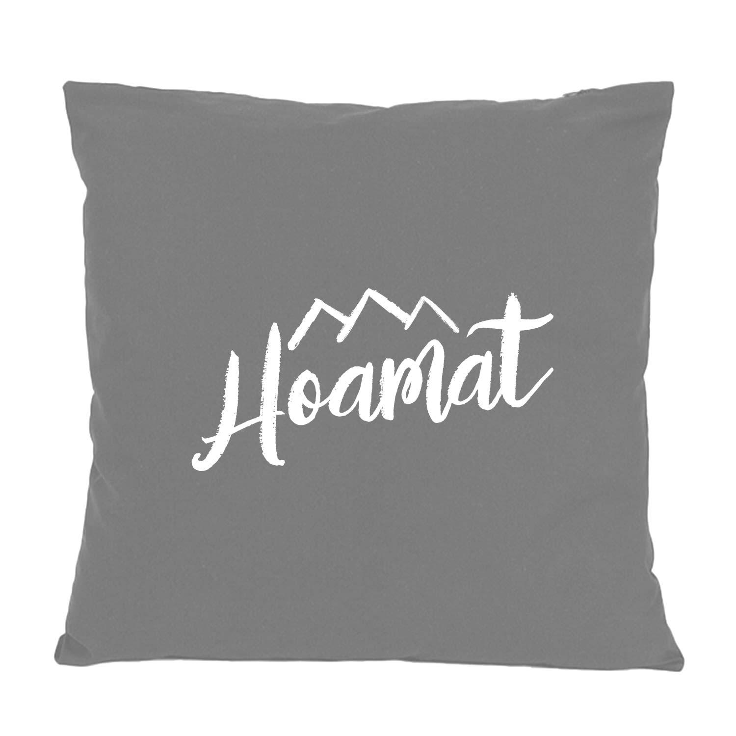 Graues Kissen Hoamat mit weißem, kalligraphischem Schriftzug und Bergmotiv, weiche Wohnzimmer-Dekoration.