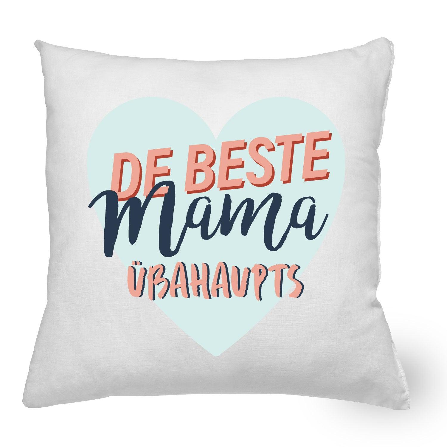 Weißes Kissen "Beste Mama" mit Füllung und blau-rosafarbenem Schriftzug auf herzförmigem Hintergrund.