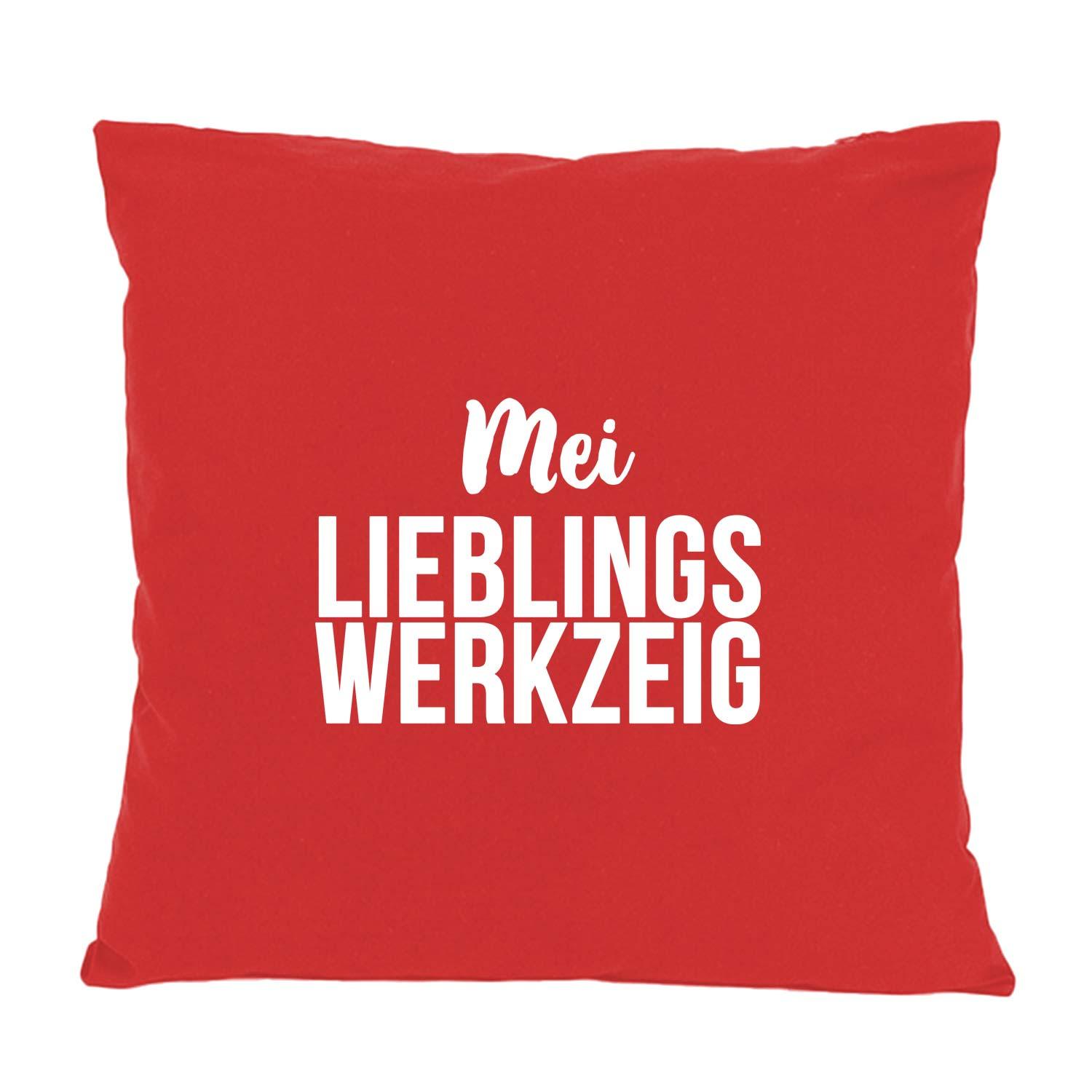 Rotes Kissen "Mei Lieblingswerkzeig" mit weißem Schriftzug, quadratisch und weich, perfekt als Deko.