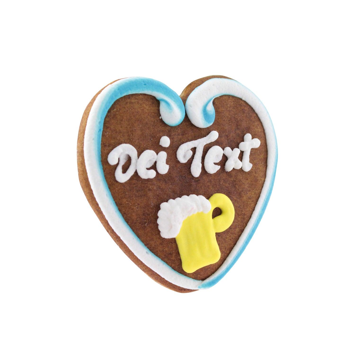 Lebkuchenherz mit blau-weißem Rand und "Dei Text" Schriftzug und Bierkrug-Motiv aus Zuckerguss.