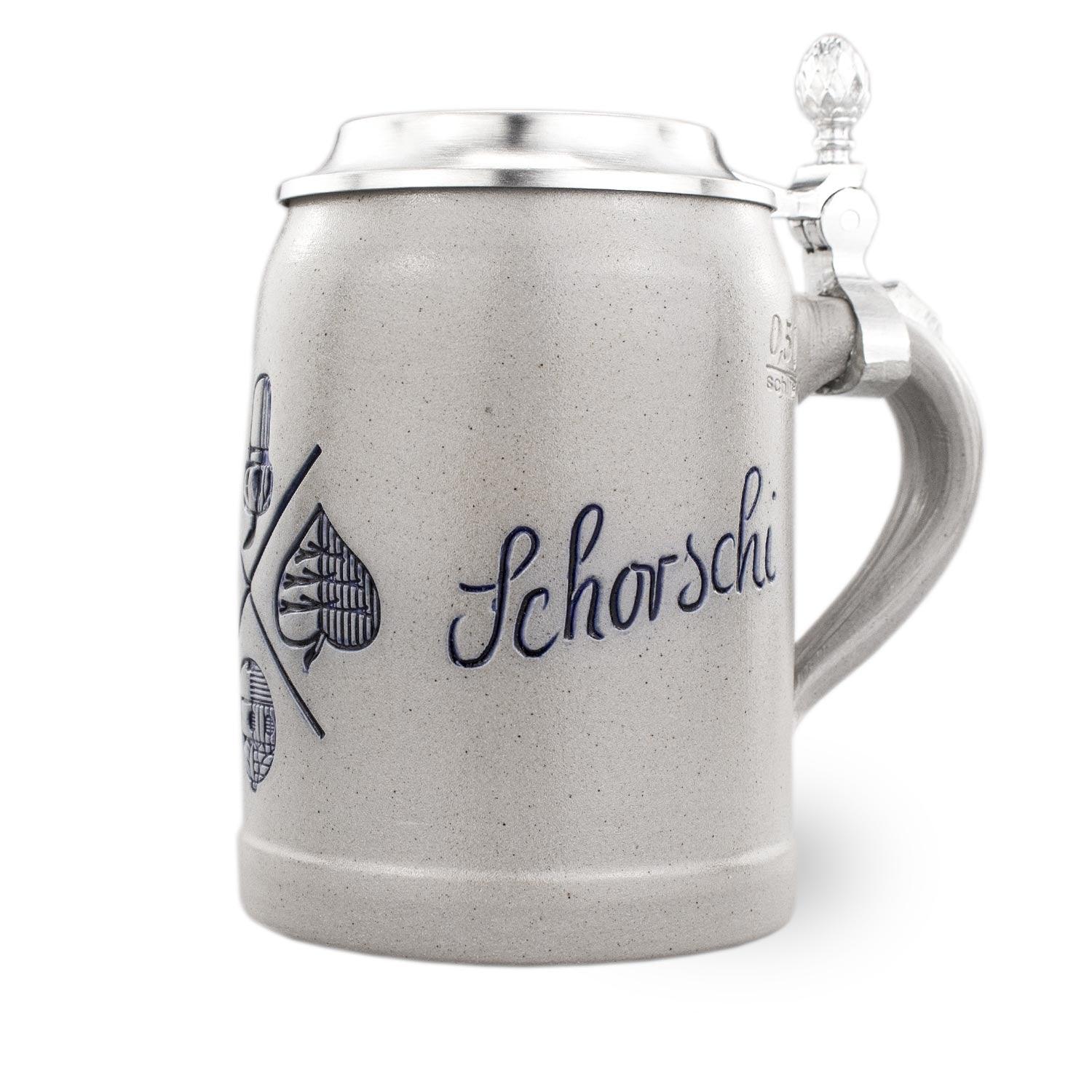 PREMIUM Bierkrug Bayrisch Blatt aus Keramik mit blauem Dekor, Zinndeckel und Gravur Schorsch auf weißem Hintergrund.