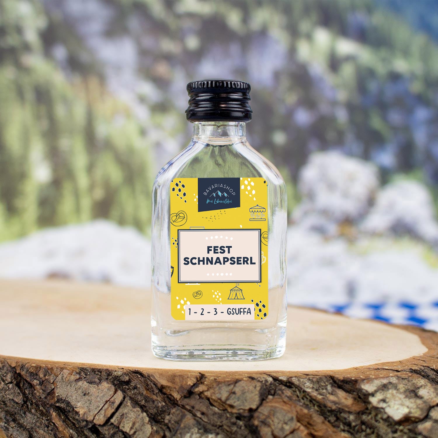 Klare Fest Schnapserl 2cl Flasche mit gelbem Etikett und bayerischen Motiven auf Holzscheibe.