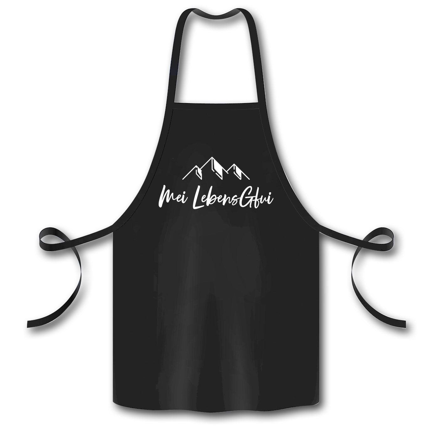 Schwarze Schürze meiLebensGfui mit weißem Bergsilhouetten-Druck und Bindebändern, ideal für Küche oder Grillen.