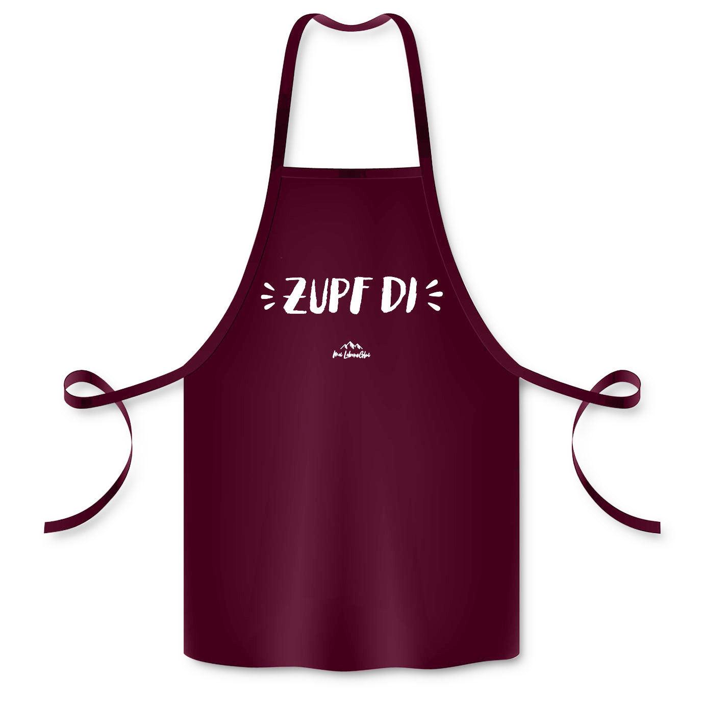 Burgunderrote Schürze "Zupf di" mit weißem Schriftzug, ideal für Küche und Grillen, strapazierfähiges Material.